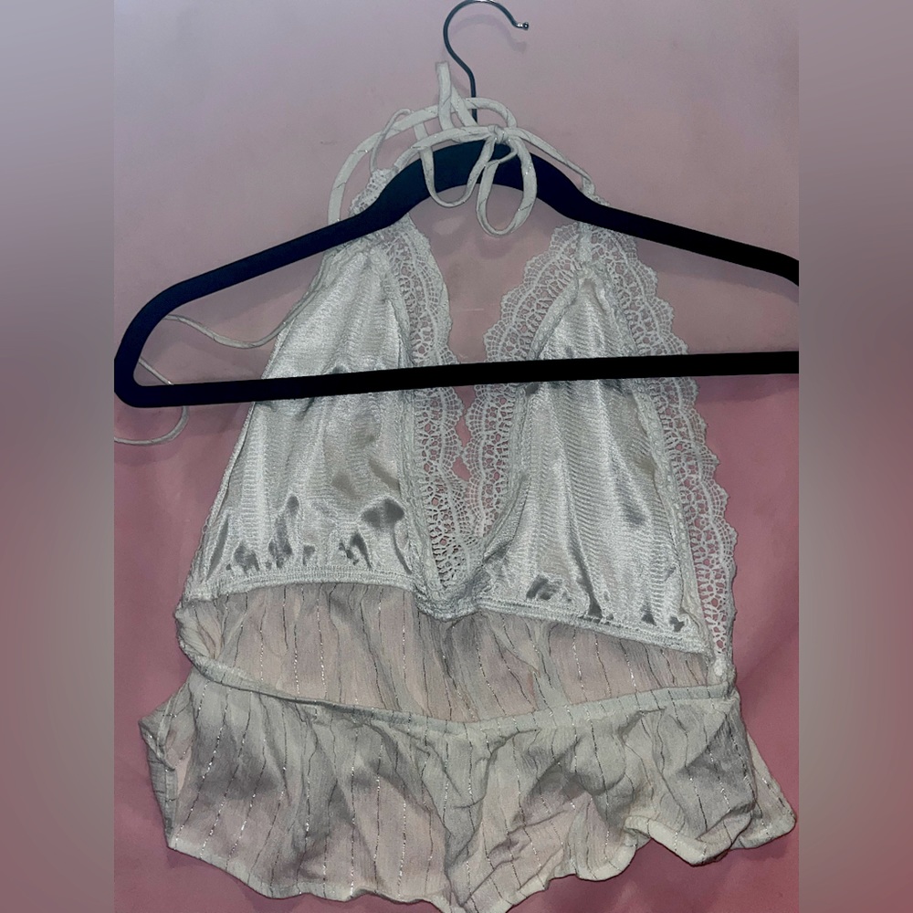 white bralette type top with silver details. ties together at the top.